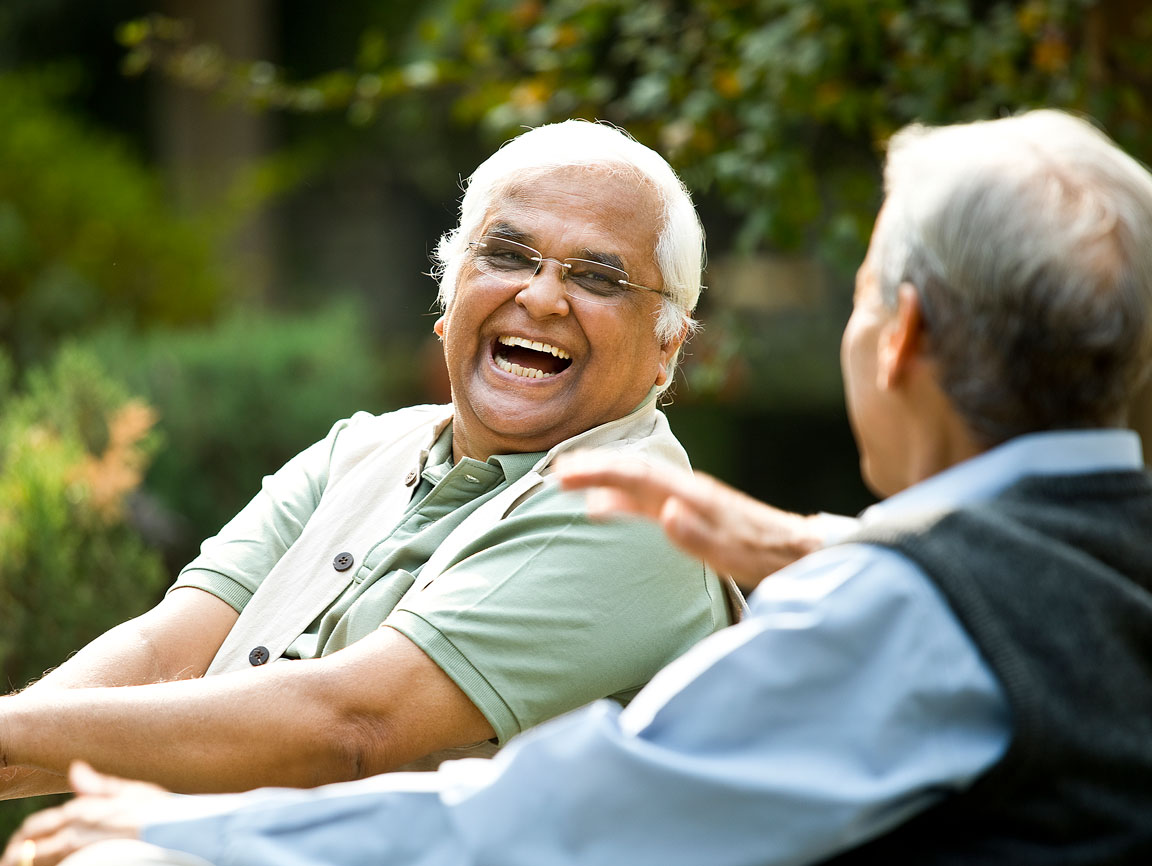 Two men sitting outside laughing